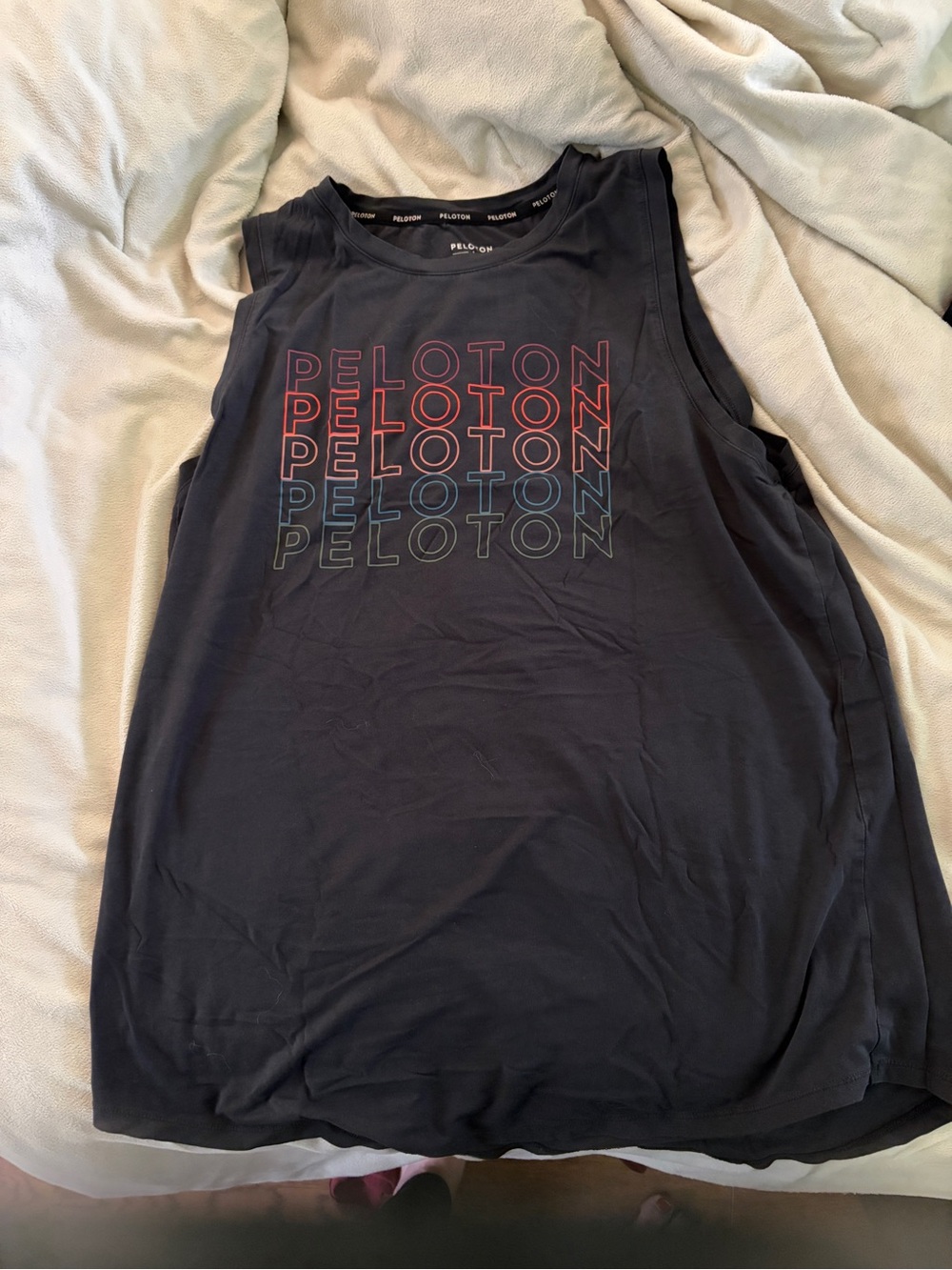Five items.  Four Peloton Logo Sleeveless Workout Tanks and one workout pant